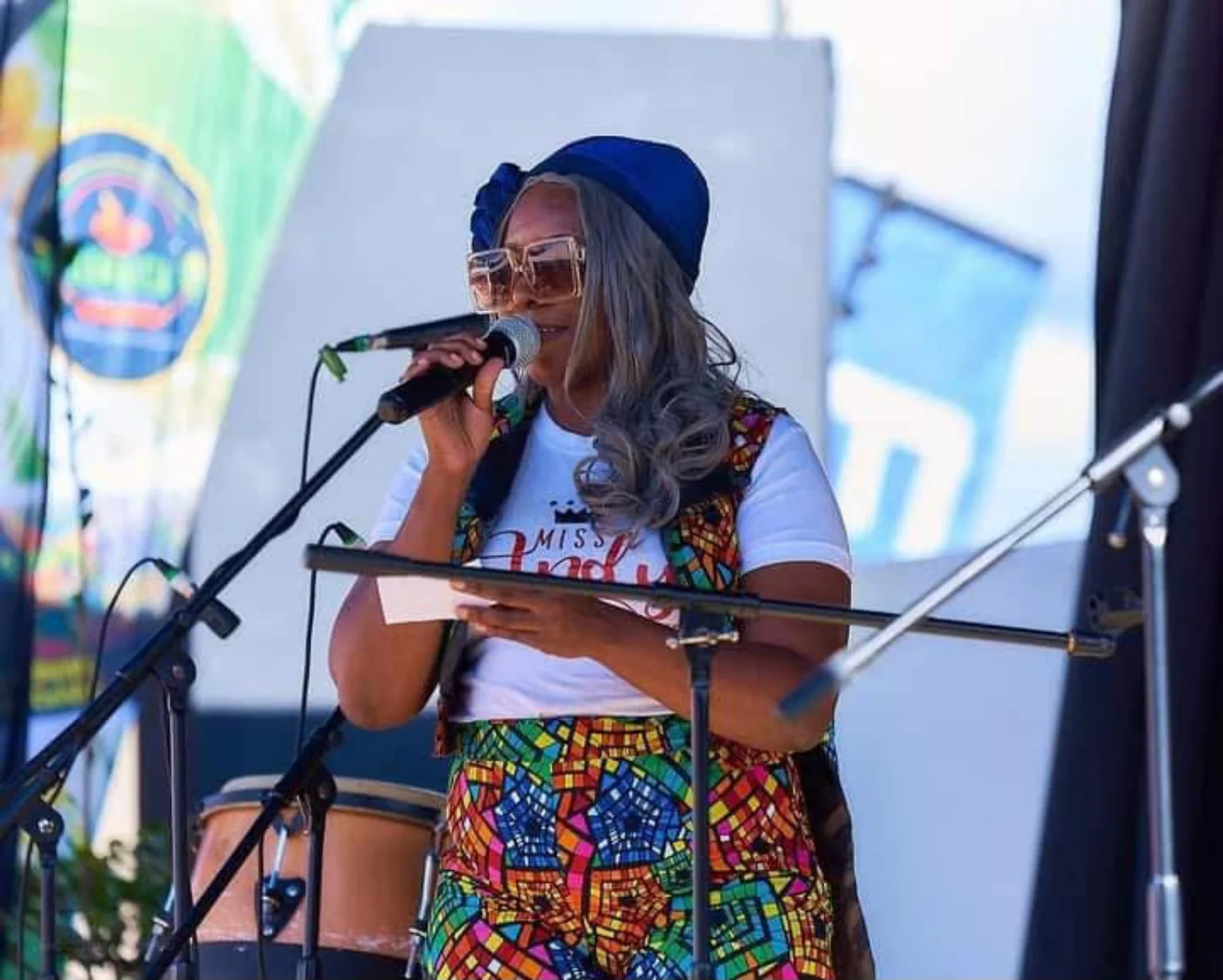 Miss Andy hosting on an outdoor stage